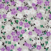 Floral pattern with purple, white, and green flowers on a gray background
