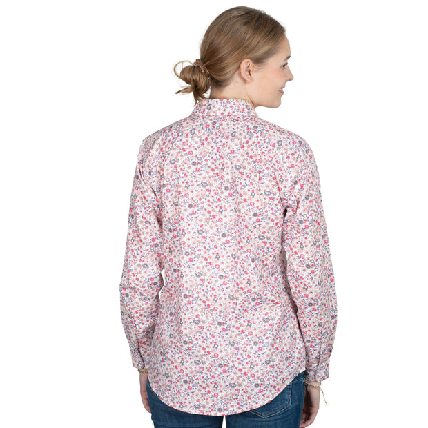 Woman wearing a floral patterned shirt on a white background