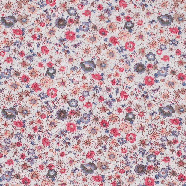 Floral pattern with small flowers in pink, blue, and purple on a light background