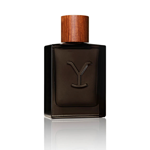 Dark brown perfume bottle with wooden cap on a white background