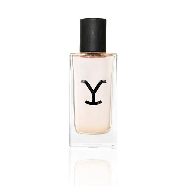 Clear perfume bottle with black cap on a white background