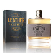 Perfume bottle and packaging labeled 'Leather Small Batch' on a reflective surface.